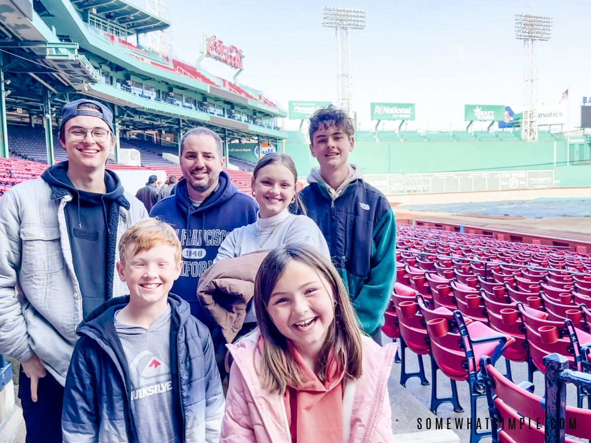 family standing in fenway park