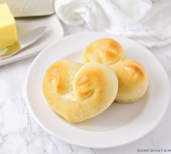 two heart shaped dinner rolls on a plate