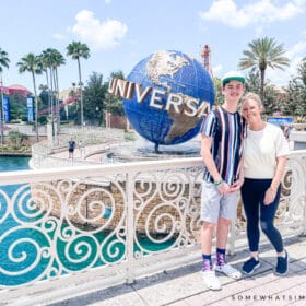 mom and son standing in front of the universal spinning globe