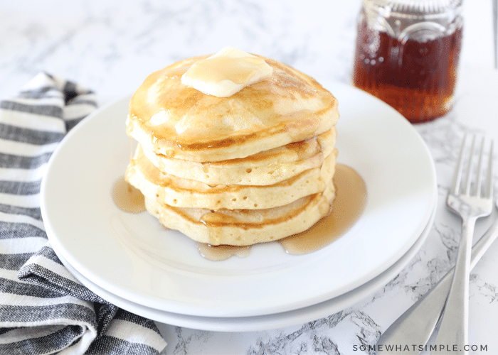 Stack of homemade pancakes with butter and syrup